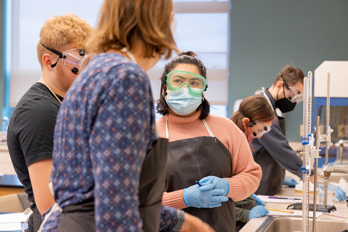 A discussion between a CCV student and professor in a science lab